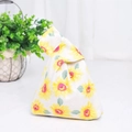 Close-up of Japanese cotton linen knot bag with yellow sunflower print and foliage - Sunflower