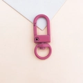 Detailed macro view of a pink matte metal swivel lobster clasp for DIY bag accessories - Rose Red