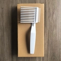 White barber fade comb for hair styling with wide and fine teeth on a dark wood background - Model B White 1Pc Kraft Box
