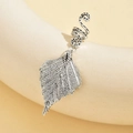 Detail of silver alloy hair ring featuring a delicate hollow leaf pendant charm - Style 3 (Hollow Leaf)