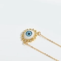 Minimalist golden Evil Eye pendant necklace with blue crystals on a thin chain - Blue