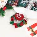 Close-up of Christmas hair scrunchie with red heart, white snowflake and festive bells - Woven Christmas Candy Hair Tie With Bell