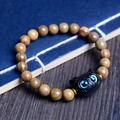 Brown wooden beaded bracelet featuring a black cat charm with blue eyes and gold spacers - Green Sandalwood 8mm*20pcs + Black Cat Head