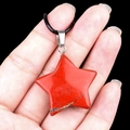 Star-shaped red jasper pendant necklace with black cord shown on hand - 30mm Red Jasper
