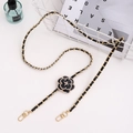 Golden metal and black leather woven phone chain strap with camellia and pearl charms - Crossbody Chain / Black