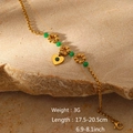Detail of gold heart charm and green beads bracelet with size specs on rock background - Heart Pendant