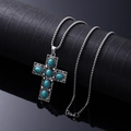 Bohemian silver turquoise cross necklace with vintage metal chain on black background - Turquoise Cross