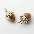 Detailed close-up of acorn pendants with gold metal caps and brown resin charms - Acorn Shape / Yellow Acorn