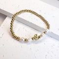 Close-up of gold beads and baroque pearls bracelet with a star and moon pendant - Moon & Star / Gold