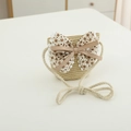 Dettaglio della borsa a tracolla in paglia per bambini con grande fiocco floreale - Borsa-Beige