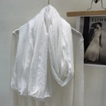 Detail of white lace linen scarf draped over a knit sweater for spring fashion style - White