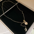 Detail of gold Y-shaped heart necklace with cubic zirconia and star moon charms - Heart Moon Star Style / Gold