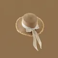 Light brown woven straw hat with cream ribbon bow and fringed brim for beach sun protection - Adjustable / Khaki-Frayed Flat Top Beige Bow