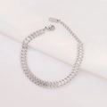Detailed macro view of silver stainless steel Cuban chain bracelet with lobster clasp - Silver
