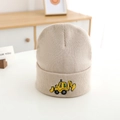 Close-up of yellow excavator embroidery on beige knitted winter hat for boys - 52-54cm / Off White
