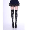 Detail of Halloween black thigh-high socks with white spider web prints on model - One Size / Spider Web