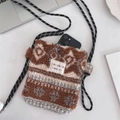 Macro view of plush heart crossbody bag showing lamb wool texture and interior storage - Diamond Brown Plaid