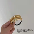 Minimalist golden hair tie with polished metallic arc design and black elastic band - 2-Layer Gold