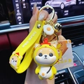 Fortune Shiba keychain featuring a yellow dog in a chicken outfit with gold bell and strap - Zodiac Rooster Shiba Inu