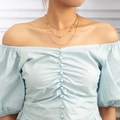 Detailed layered gold necklace showing star charms and white imitation pearls on model - Gold Star Artificial Pearl Chain (NZ1278)