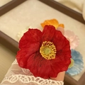Elegant red mesh poppy flower hair clip shown held by a white lace glove for women - Red Poppy