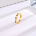 Minimalist gold titanium steel ring with square crystals on a white reflective surface - Ice Cube Row Zirconia Gold