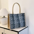 Stylish large leopard print jute tote bag with woven handles on a minimalist table - Grey Leopard