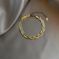 Braided triple herringbone snake chain bracelet in polished gold finish with lobster clasp - E96 Three-Strand Criss-Cross Gold Bracelet
