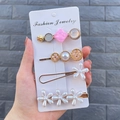Detail of candy-colored hair clip set featuring pearls and floral motifs in hand - Morning Sun (4 Piece Set)