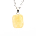 Detail view of a rectangular yellow raw crystal pendant on a silver metal chain - Silver + Topaz Color