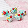 Macro detail of hand-painted beads with 3D strawberry, flower and heart patterns - Green Cream + Watermelon + Heart