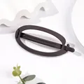 Close-up of matte dark brown oval hair claw clip with minimalist frosted texture finish - Oval - Gray Purple