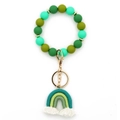 Green silicone bead keychain bracelet with hand-woven rainbow charm and white tassels - Green