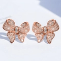 Macro detail of rose gold bow earrings with micro-pave cubic zirconia gemstones - E3880 Stud Earrings