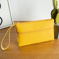 Bright yellow pebbled leather wristlet with dual zippers and gold hardware detail - Yellow