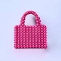 Detail of pink acrylic pearl beads on a handmade woven handbag with beaded handle - Rose Red