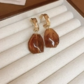 Close-up of heart-shaped amber resin earrings with golden metal in a jewelry box - Irregular Square (5#) / Amber Brown