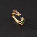 Macro detail of gold crossover ring featuring multi-color rectangular zircon stones - Rainbow Double Ring Cross Style