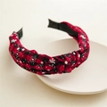 Close-up of a wide red and black buffalo plaid headband with white snowflake patterns - Twisted Knot / Red and Black Plaid (Snowflake Print)