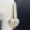 Detailed close-up of the plush heart-shaped bag with soft white faux fur and grey tips - White
