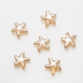 Detailed view of starfish glass beads with textured gradient brown finish for DIY jewelry - Amber Gold