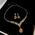 Silver teardrop necklace and earrings set with yellow stones on black velvet background - Necklace-Gold-Yellow