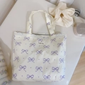 Detail of canvas tote bag with purple bow pattern and secure gray zipper closure - White Base Light Purple Bow