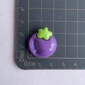 Macro detail of purple resin mangosteen charm on a measurement grid showing 2cm size - Purple Eggplant