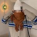 Brown tassel cashmere-feel scarf paired with a beige knitted beanie on a model - Caramel