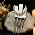 Detail of moon-shaped bridal hair comb with natural white crystals on stone background - Howlite