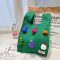 Green knit tote bag with colorful mini hat charms and woven brand label details - Colorful Hat Green