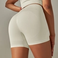 Detail of high waist seamless knit workout shorts with breathable texture and push-up effect - S / Cream