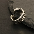Detalle de anillo punk vintage con diseño de pin sobre fondo de piedra texturizada - Abierto Ajustable / Diseño Cadena Trenzada-Plateado (RG0121-B)