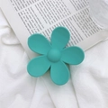 Close-up of green matte flower hair claw clip with detailed five-petal design for girls - Emerald
